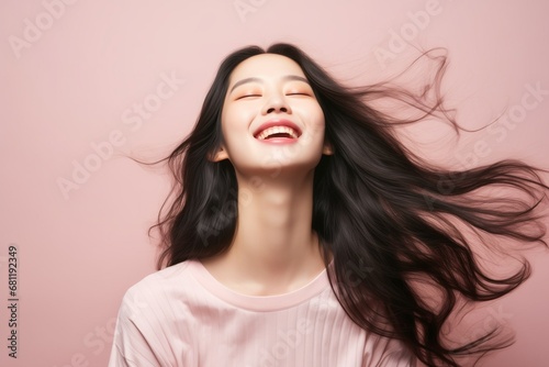 Beautiful gorgeous young korean woman model with long shiny hair smiling. Beautiful clean young asian close up portrait on pastel pink. Healthy face skin care beauty, Eco Bio skincare cosmetics.
