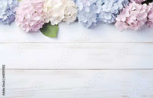 colorful pastel hydrangea flowers on white wooden table for greeting holiday card decor