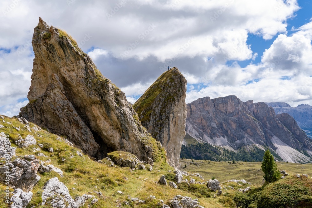 some big rocks that are in the grass on a mountain: Italy, Dolomites mountains