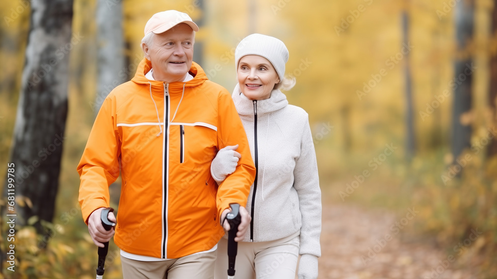 Active hiking rest outdoors of mature couple concept. Senior elderly man and woman training Nordic walking with ski trekking poles in autumn forest Active hiking rest outdoors of mature couple concept. Senior elderly man and woman training Nordic walking with ski trekking poles in autumn forest