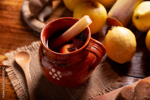 Mexican Ponche. Christmas fruit punch is a hot fruit-infused drink, traditionally consumed in the winter season during posadas and Christmas Eve. Made with sugar cane, piloncillo and fruits. photo
