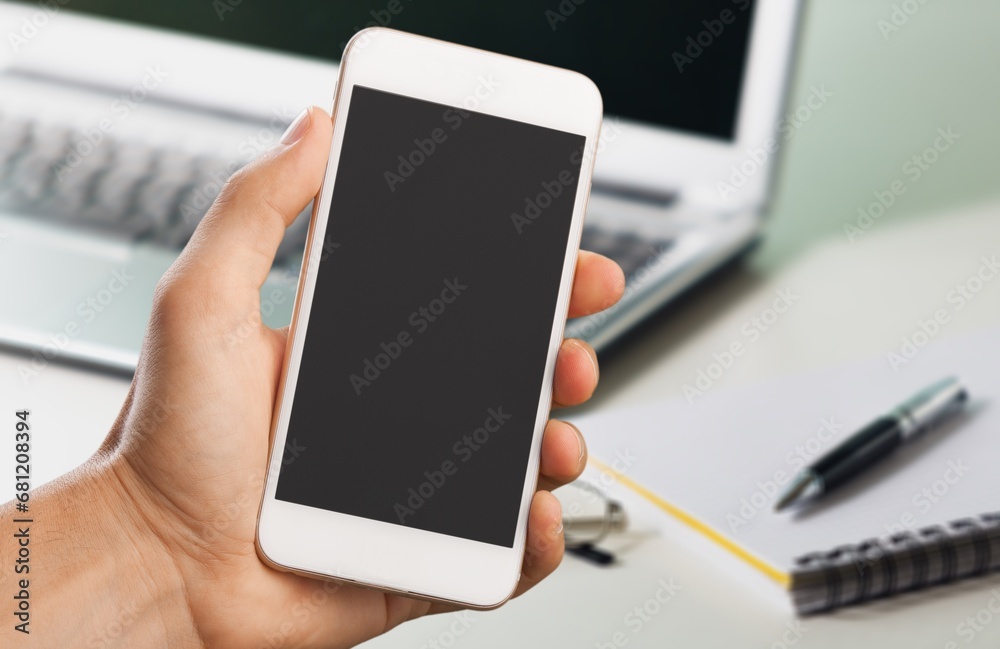 Smartphone with blank screen at desk background