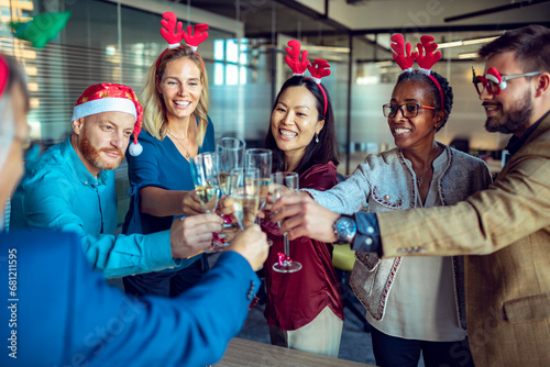 Business people drinking champagne during new year and Christmas holidays at the office photo