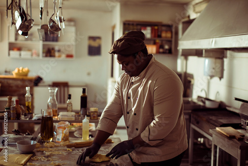 Professional chef preparing dough in restaurant kitchen photo