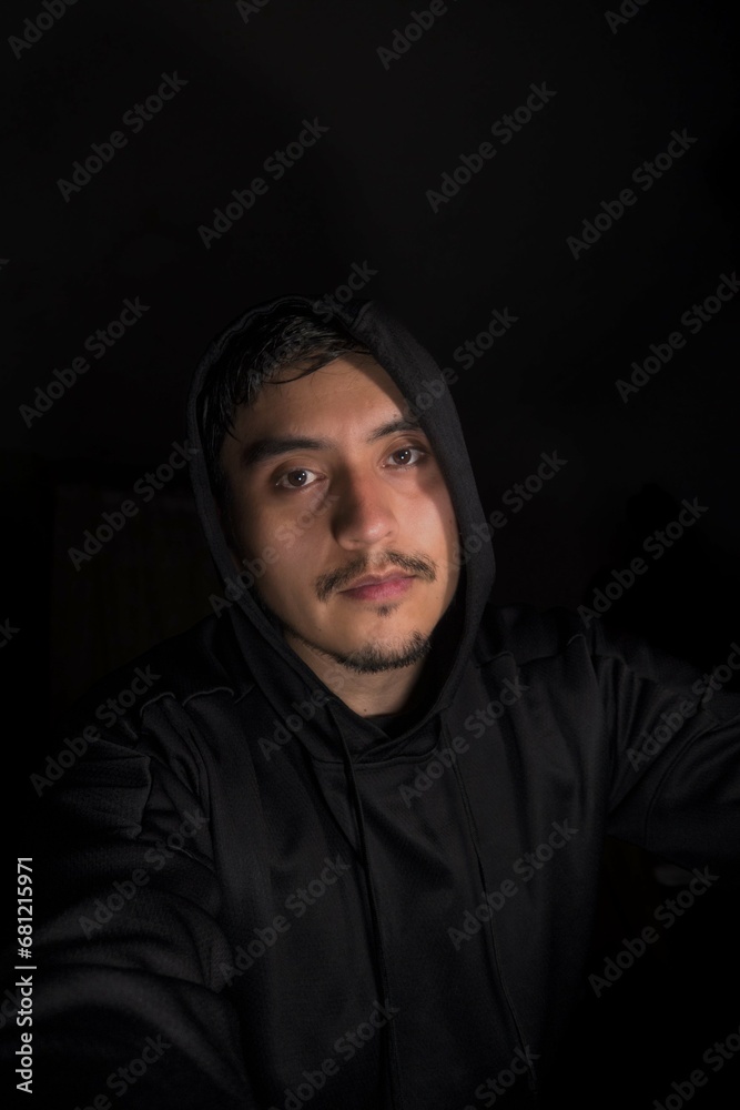 Portrait of lmexican man wearing sweatshirt, hat and looking at camera kindly Portrait of lmexican man wearing sweatshirt, hat and looking at camera kindly