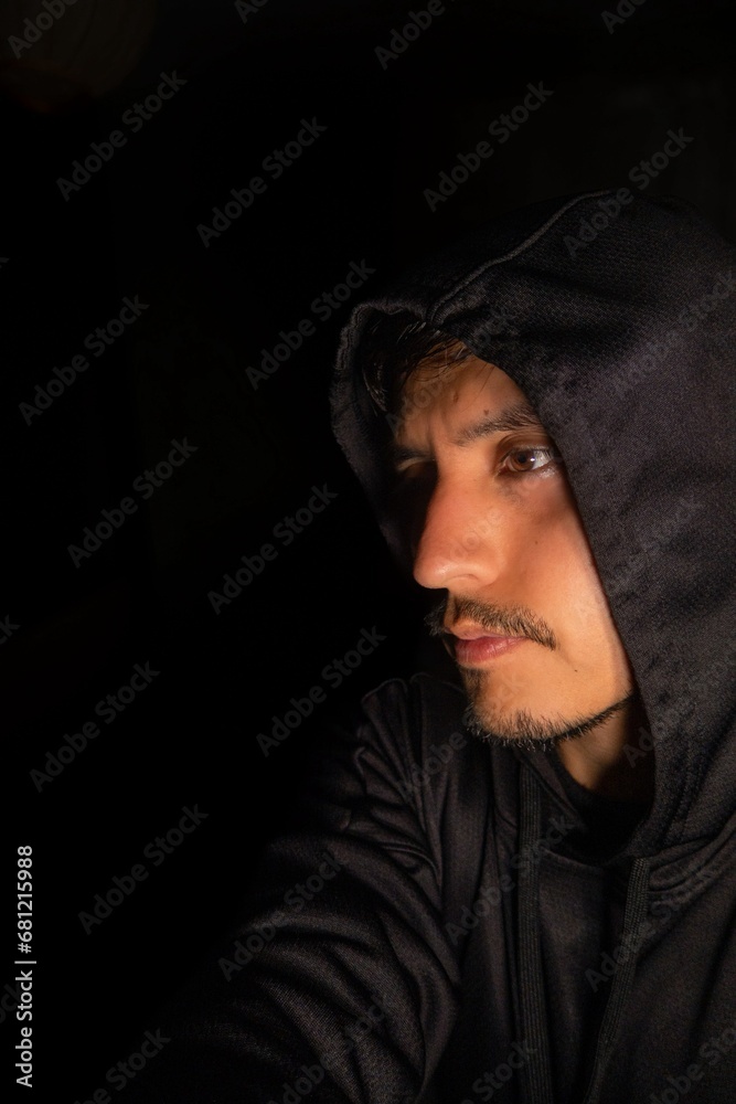 Portrait of mexican man in sweatshirt and hat looking left with space for text