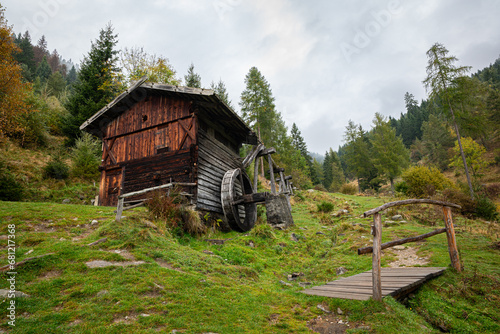Old wooden water mill on a mountain near the place of Terenten in Puster Valley in South Tyrol, Italy photo