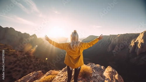A young woman, alone in nature, seen from behind in front of a canyon, ready to cross the desert, a journey through the difficulties and trials of life, towards the unknown, adventure freedom