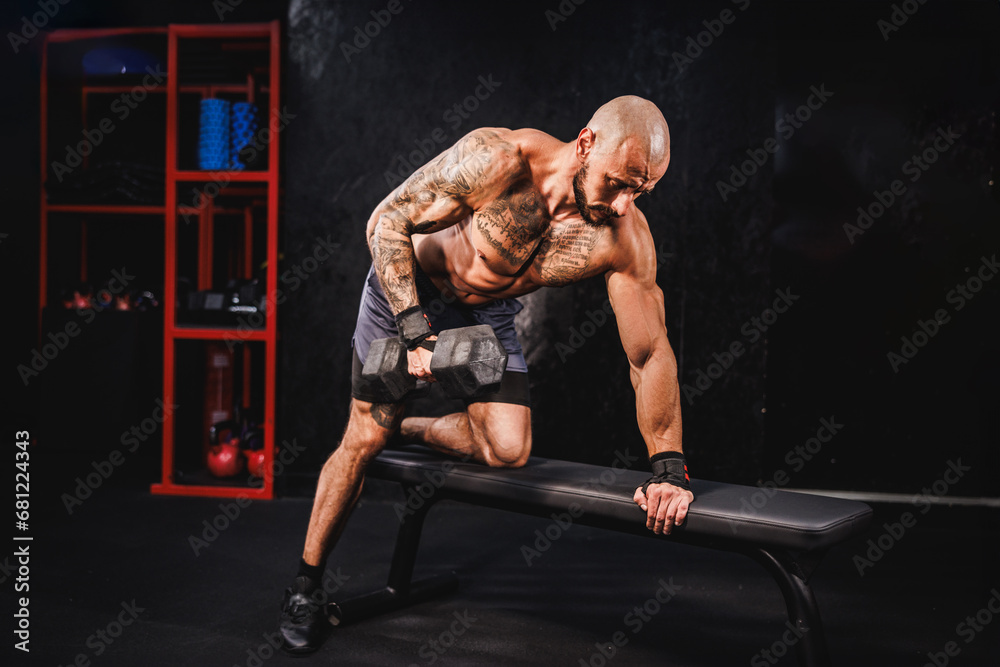 Man Doing Training With A Dumbbell For His Back Muscle At The Gym Man Doing Training With A Dumbbell For His Back Muscle At The Gym