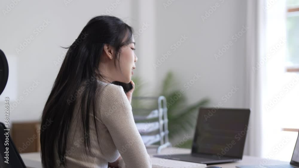 Young female making business call talking on the phone Young female making business call talking on the phone