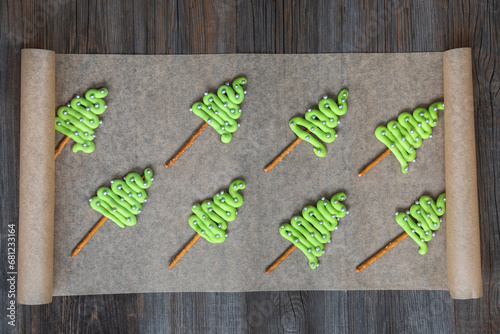 Green chocolate Christmas trees on parchment paper. Christmas party concept.