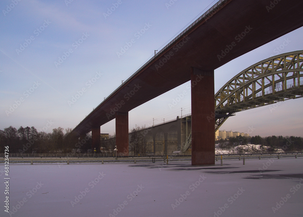 Low angle view of bridge over river against sky Low angle view of bridge over river against sky