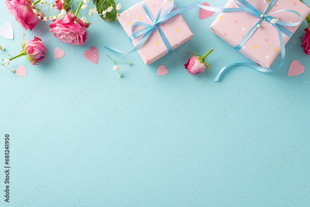 Valentine's Elegance: Top view arrangement with wrapped gifts, pink roses, gypsophila, and glittering heart confetti. Pastel blue background allows for text or advertising