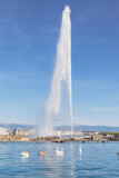 Panoramic view of Geneva skyline with famous Jet d'Eau fountain and boats at harbor district Geneva, Switzerland