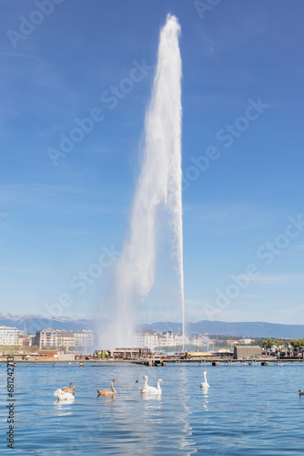 Panoramic view of Geneva skyline with famous Jet d'Eau fountain and boats at harbor district Geneva, Switzerland
