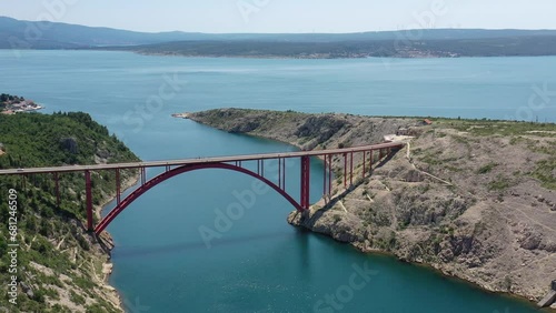 Maslenica Bridge Most in Croatia. The Maslenica Bridge is a deck arch bridge carrying the state road spanning the Novsko Zdrilo strait of the Adriatic Sea. Beautiful Landscape in Background photo