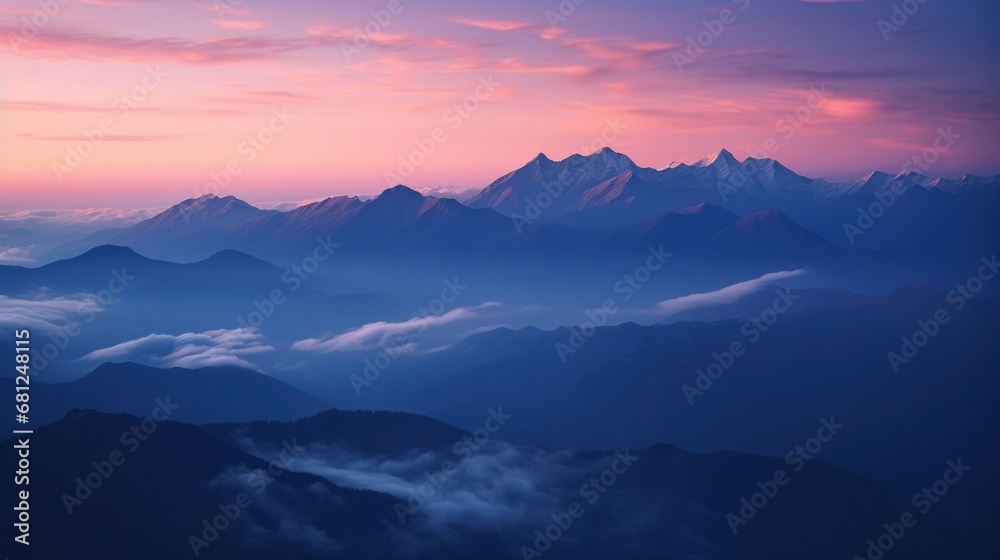 A stunning sunset over majestic mountains, adorned with clouds, creating a picturesque scene.