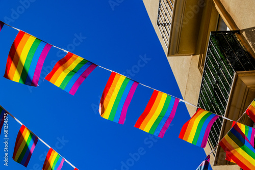 Fototapeta Naklejka Na Ścianę i Meble -  small rainbow flag against the sky in a Spanish city