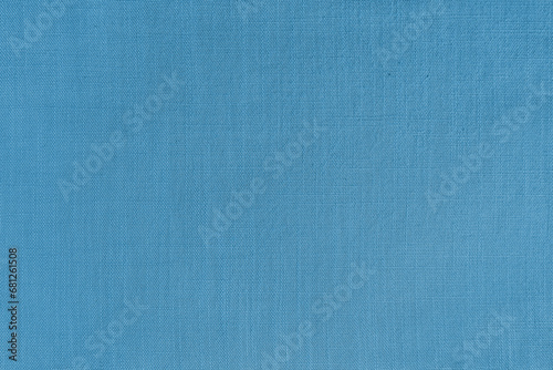 Texture background of blue linen fabric. Textile structure, cloth surface, weaving of natural cotton fabric closeup, backdrop, wallpaper.