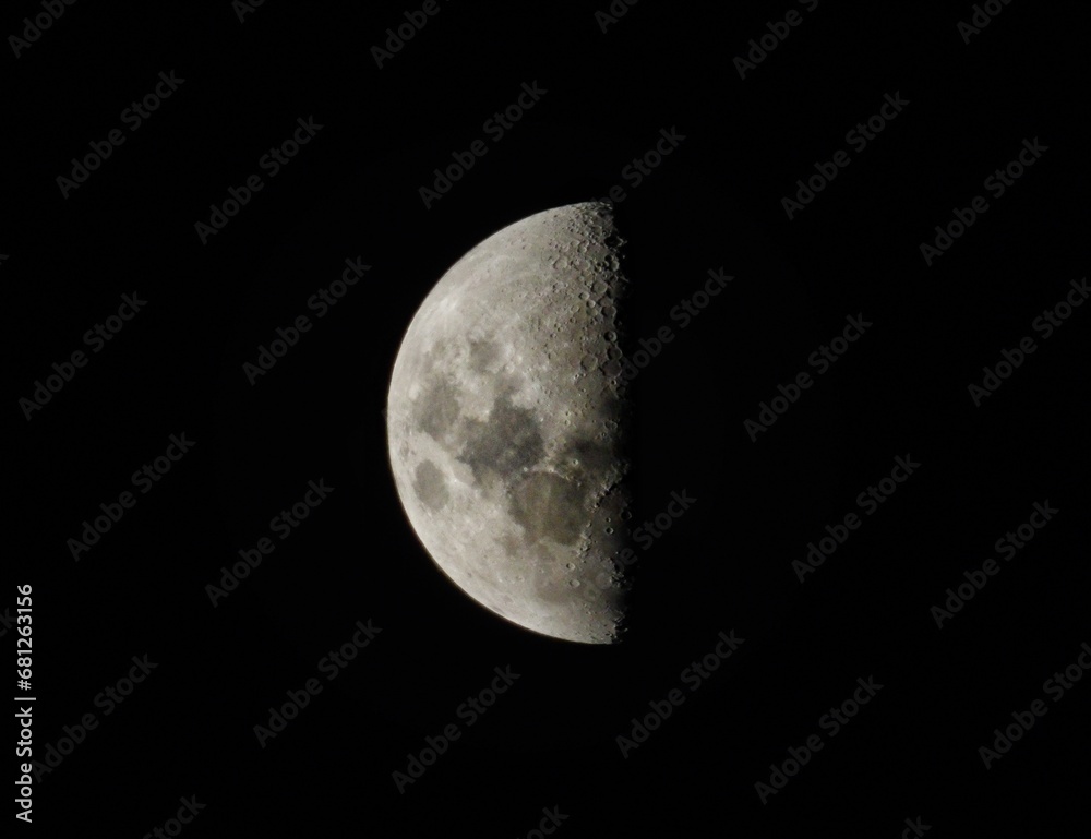 an image of the moon illuminated exactly 50% an image of the moon illuminated exactly 50%
