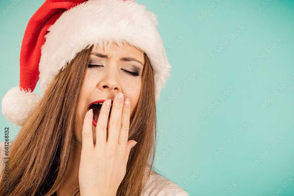 Woman in santa hat being sleepy Woman in santa hat being sleepy