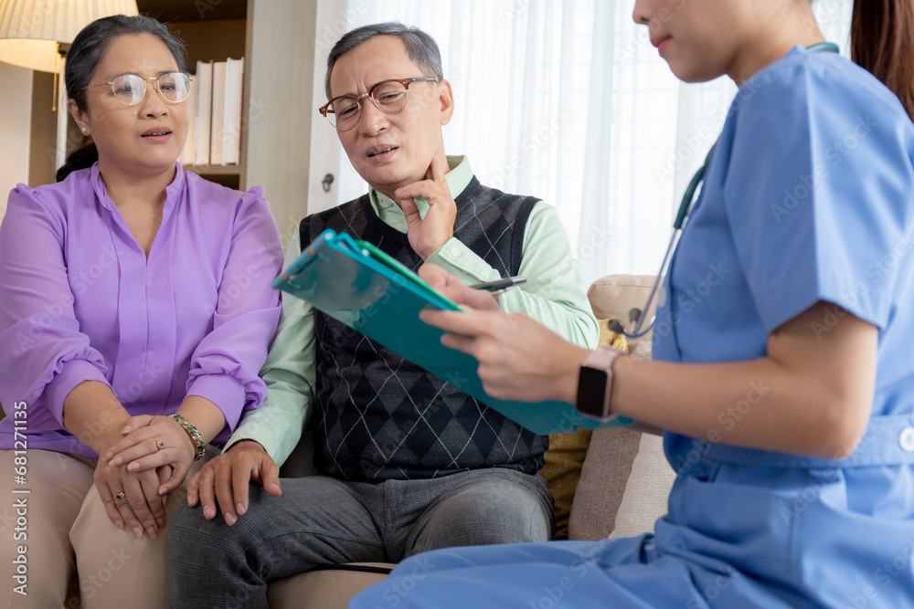 Caregiver sitting on sofa checkup and diagnostic with elderly couple patient about health in living room at home, caretaker sitting on couch explaining and examining senior, insurance and medical.