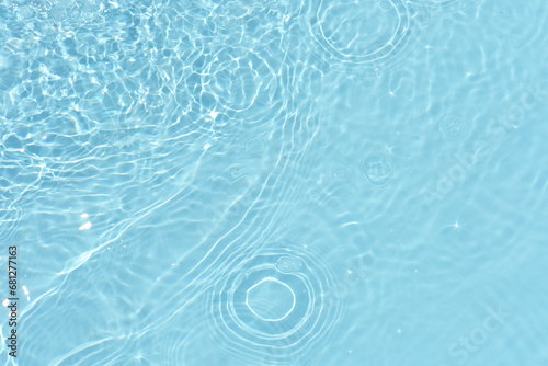 Fototapeta Naklejka Na Ścianę i Meble -  Blue water with ripples on the surface. Defocus blurred transparent white-black colored clear calm water surface texture with splash and bubbles. Water waves with shining pattern texture background.