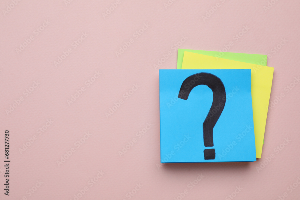 Sticky note with question mark on color background, top view. Space for text Sticky note with question mark on color background, top view. Space for text