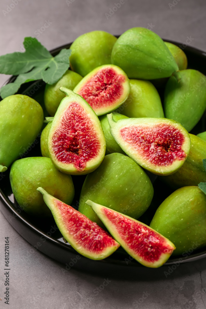 Cut and whole green figs on light gray table, closeup Cut and whole green figs on light gray table, closeup