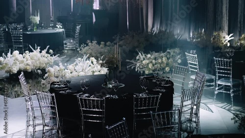 In the banquet hall there are festive tables set for guests. photo