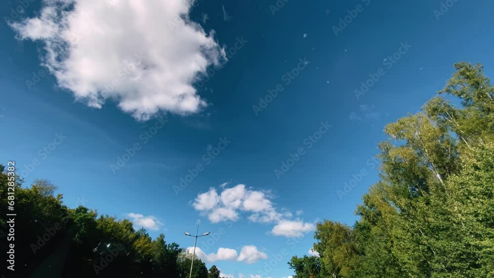 Shooting the sky from the cab while the car is moving. The camera is aimed through the glass up at the clouds