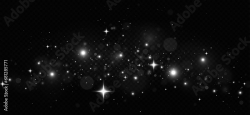 The dust sparks and silver stars shine with special light. Silver dust white sparks and silver stars. Christmas Abstract stylish light effect on a black transparent background.