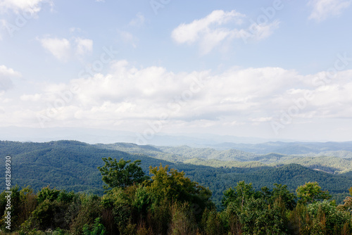 Beautiful mountain landscape from a bird's eye view of a blue mountain, endless horizon and trees in the foreground. Sassafras Mountain, South Carolina 29635, USA