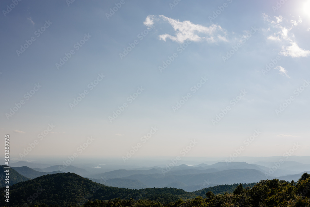 Beautiful mountain landscape from a bird's eye view of a blue mountain, endless horizon and trees in the foreground. Sassafras Mountain, South Carolina 29635, USA