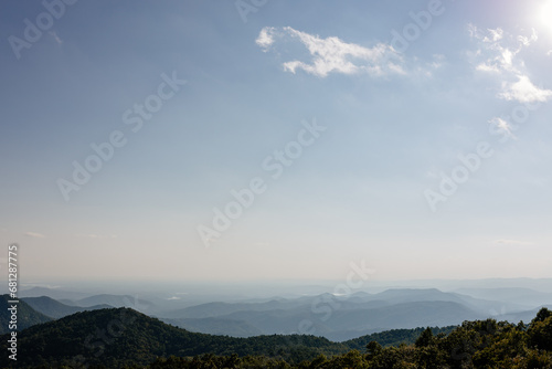Beautiful mountain landscape from a bird s eye view of a blue mountain  endless horizon and trees in the foreground. Sassafras Mountain  South Carolina 29635  USA