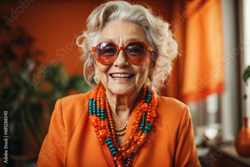 A high self-confident old woman. Laughing happily in a bright orange outfit Wearing cool sunglasses in her store