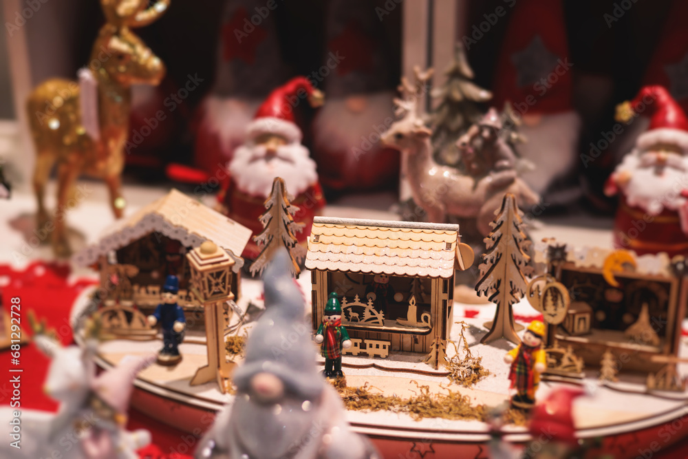Crowded Christmas market fair with New Year decorations, balloons, garlands and festoons, XMas fair interior, retail sale kiosk and store with illumination, stalls with handmade gifts souvenirs