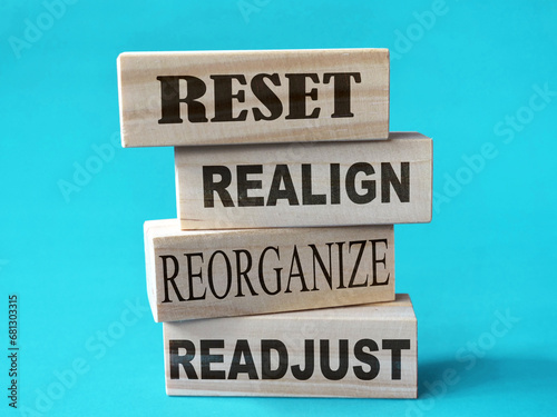 Reset realign readjust, word text written on wooden block, life business term photo