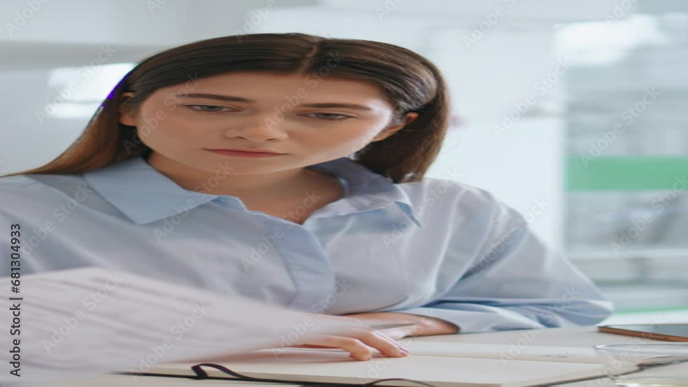Young assistant working boss in office. Focused manager checking papers vertical Young assistant working boss in office. Focused manager checking papers vertical