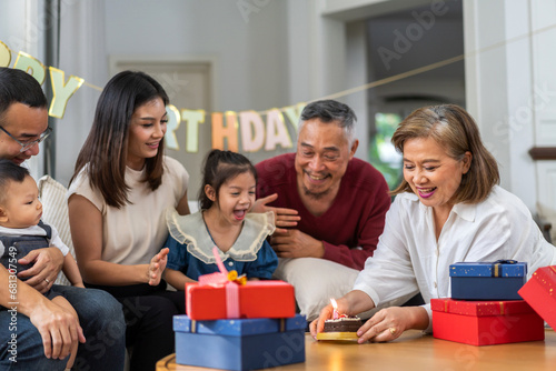 Portrait of happy love asian big family father and mother with asian baby and little girl happy birthday, party, celebration, cake, surprise together.Family party