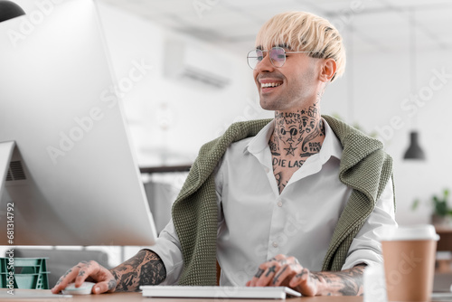 Young tattooed man working ...