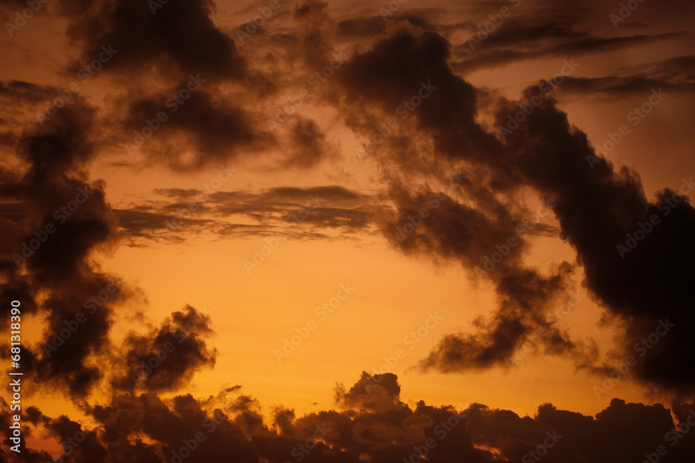 Fototapeta premium Golden sunset sky with border of dark clouds