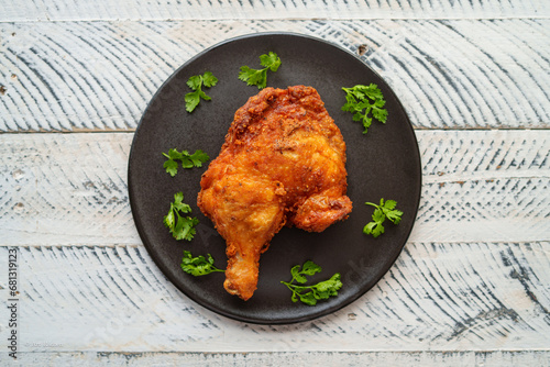 Crispy chicken thighs fried on a wooden table