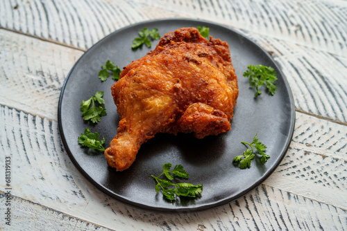 Crispy chicken thighs fried on a wooden table
