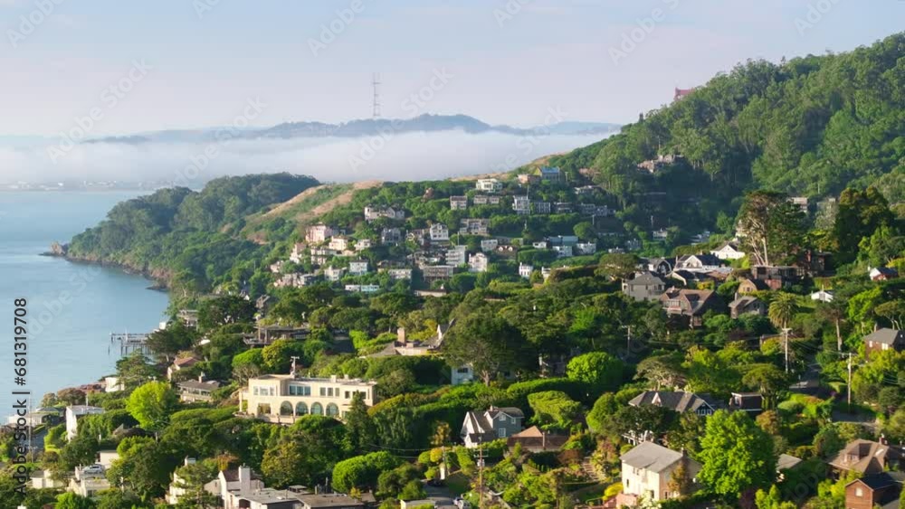 Aerial view of Sausalito landscape with cute houses at the Pacific Ocean, San Francisco area, California, West coast, USA. Breathtaking shot of San Francisco suburban with Golden Gate bridge in fog