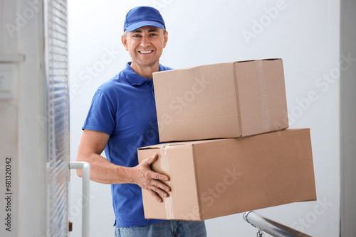 Mature courier with parcels...