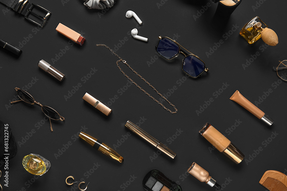 Composition with female accessories and cosmetic products on dark background
