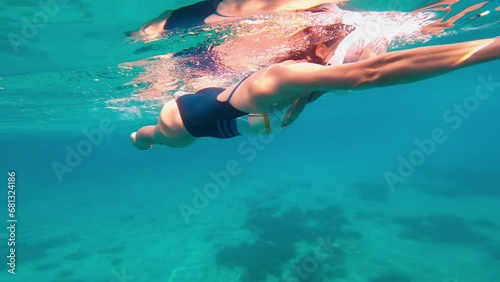 Female uses underwater scooter. Leisure, vacation time. photo