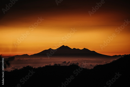 View of mountain with fog at sunset