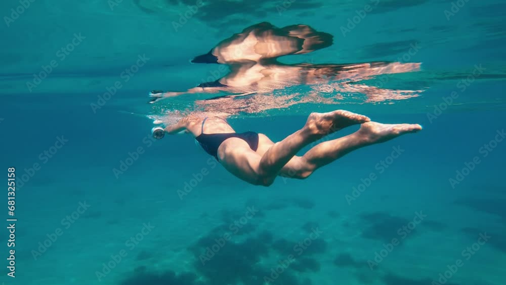 Deep underwater diving with modern sea scooter.